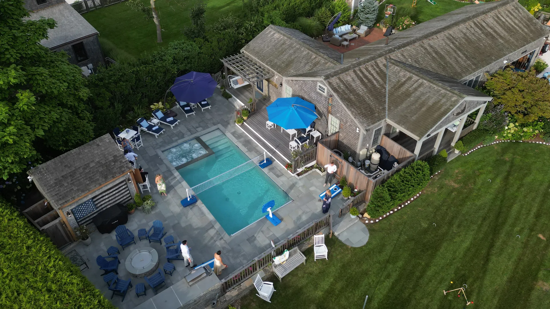 The Hummock Hideaway pool from above, with its swim-up spa, volleyball net, cabana bar and fire-pit ring.